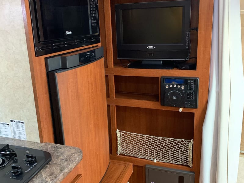 tv area, microwave, and fridge