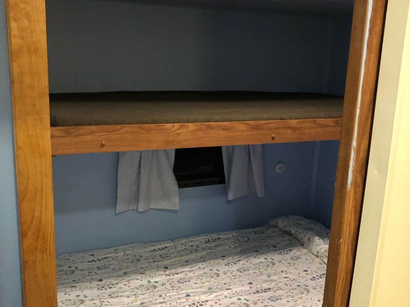 looking into bunk room. upper bunk will sleep one and bottom bunk will sleep two (full size bunk)