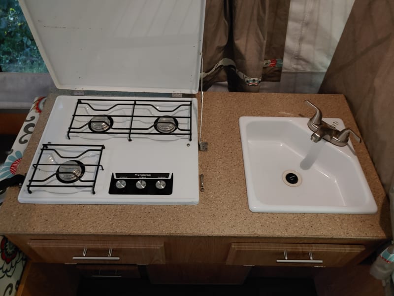 Propane stove and sink.