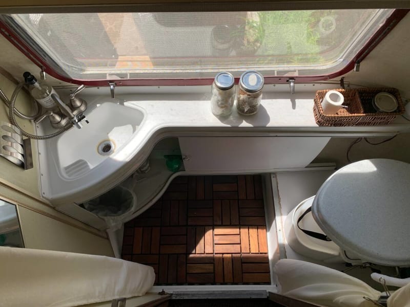 Rear bathroom with Nature's Head composting toilet. Teak mat for showering. 