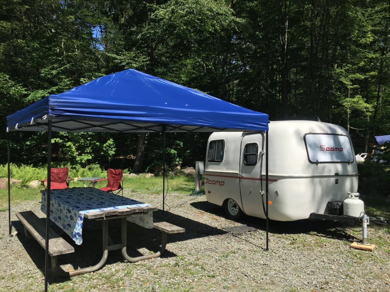 1985 Scamp All American trailer with pop up awning, camp chairs and table cloth - all included in rental.
