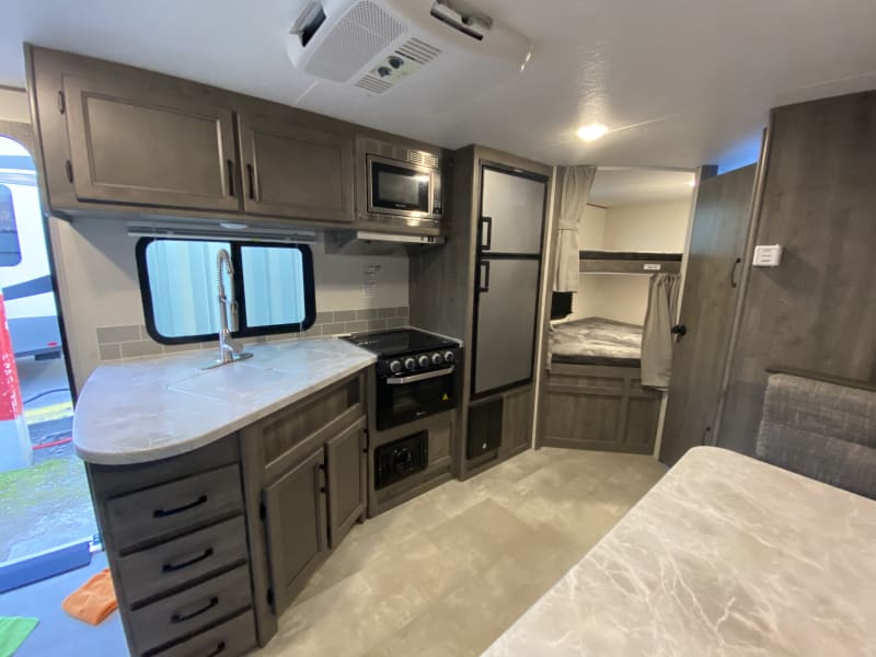 Oven, 3 burner stove, microwave, fridge/freezer