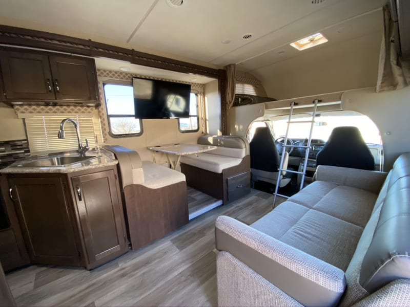 Dining table, convertible couch, above the cab bunk and kitchen.
