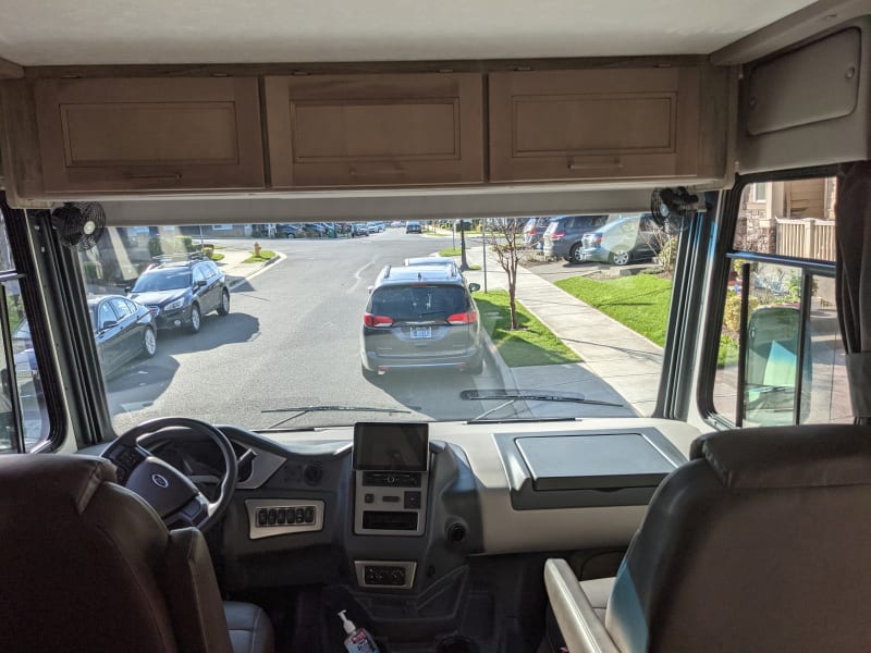 View of the Cockpit with Bunk in travel position.  Chairs swivel but have conflict with seat belt so we leave them facing forward.