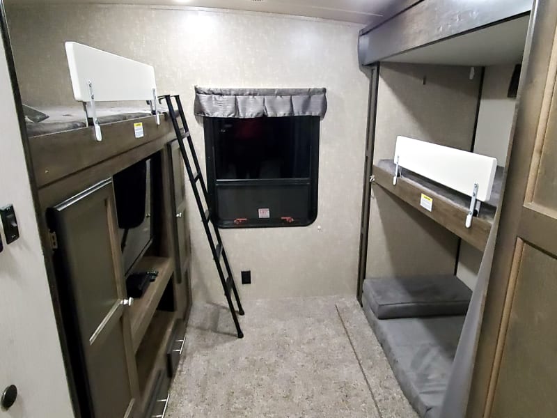 Spacious bunkhouse that sleeps at least 4 adults.  Only 1 sleeper chair shown but there will be 2.  Bunk bed rails are easily removed if not needed.