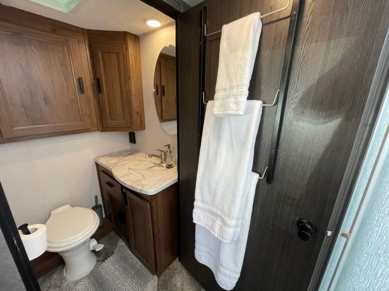 Separate toilet room across from shower. Door is magnetized to provide more privacy for shower and toilet space!
