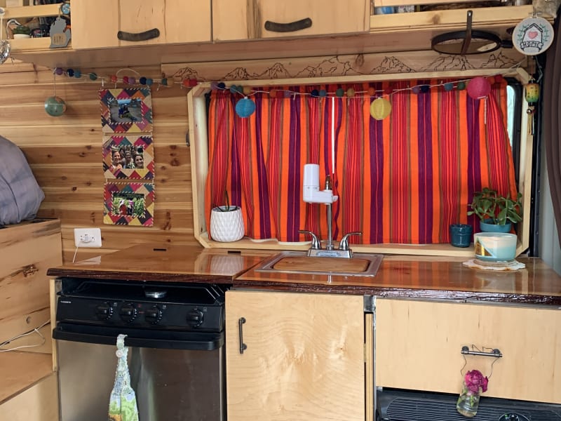 3 burner stove top, oven (decent sized for pizza, etc). Basic cook ware included. lots of counter space. 