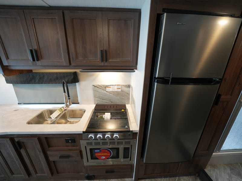 Kitchen: large fridge, sink, roomy counter top, stove