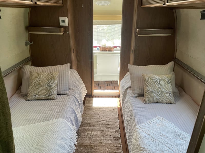Permanent twin beds in rear of Airstream. View is from front to back.