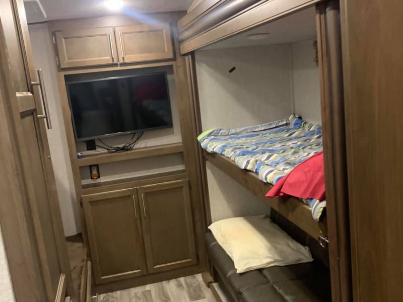 Bunkroom with 2 sets of bunks and a TV.