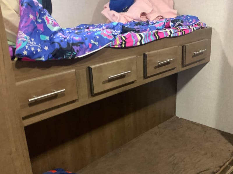 Bunkroom with 2 sets of bunks and a TV.