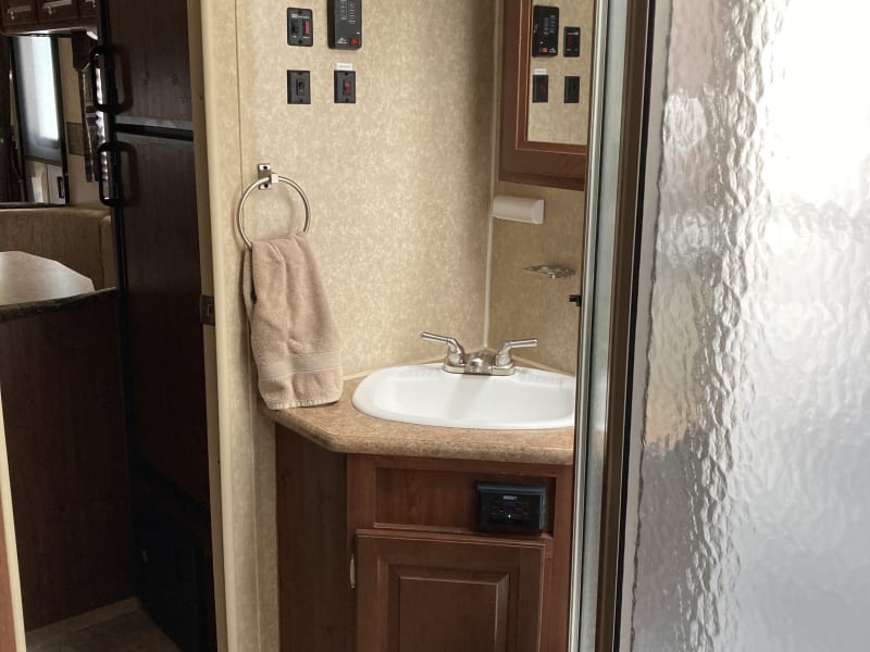 …sink and shower to the left of walk through bathroom. 