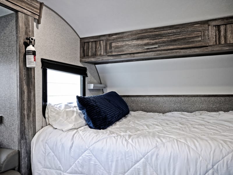 Queen bed with overhead storage.
