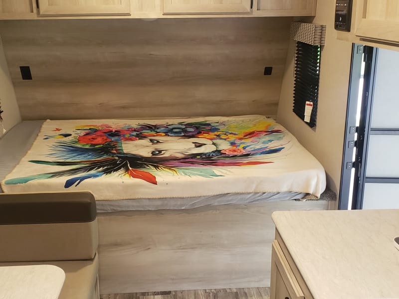 Full-sized bed and deep overhead storage for all your clothes and belongings.