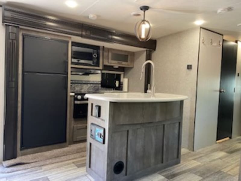 Spacious full kitchen with an island sink.