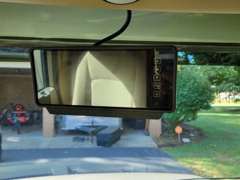 Has backup camera and side camera when turning. The camera can be used while driving to see behind you.