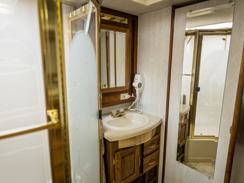 Bathroom with vanity mirror and hair dryer. Lots of storage.
