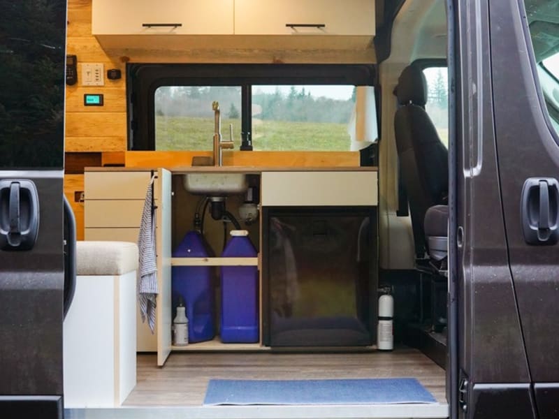 Van comes equipped with 5 gal water tank, 5 gal grey water tank with water pump for running water for dishes. 