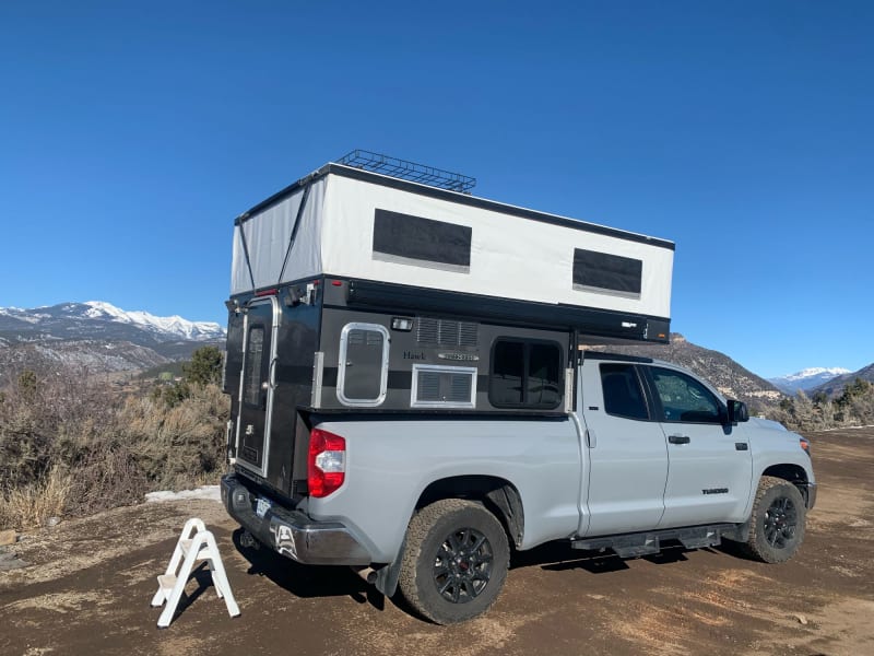 Outdoor access to two 10 gallon propane tanks, sliding window, awning, easy rear access to camper