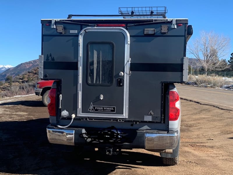 Easy entry to camper, rear hitch to attach bike rack, plenty of exterior lighting, water drain, locking camper door