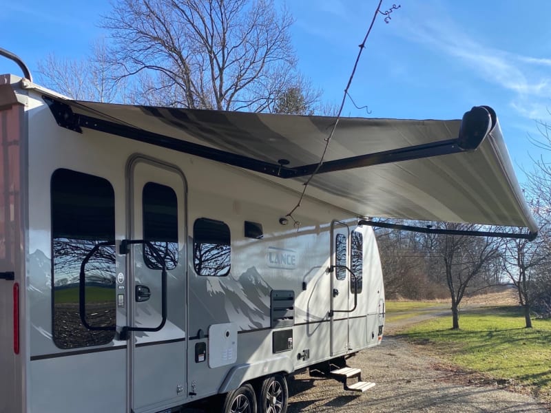 This is entrance and exit of our Lance with awning out. We’ll include 2 law chairs to enjoy it! We also have a large mat to place your chairs. 