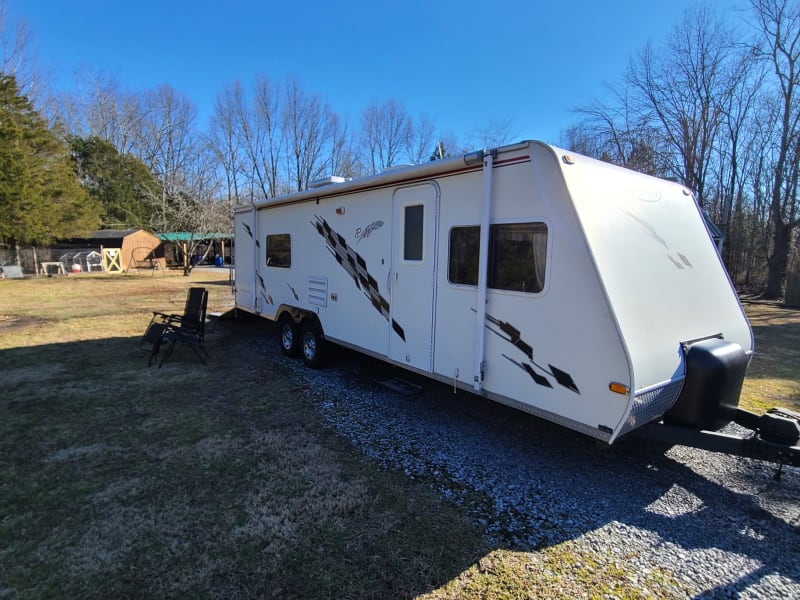 Entry side of camper showing awning rolled up.  Awning is fully functional with no leaks, tears.