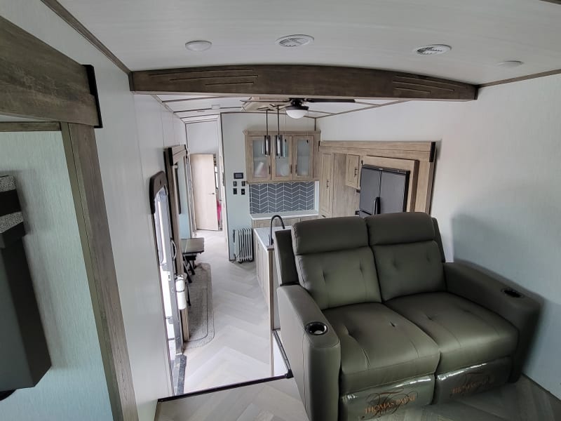 This gives you a better idea of how roomy the fifth wheel is inside. From the living room you can look down on the kitchen and dining room.