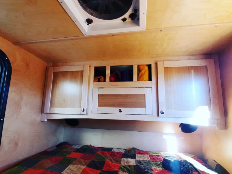 Interior cabin cabinets and Bluetooth radio and solar panel reading. Lots of games ,extra blankets ,towels for showers or lake/beach.