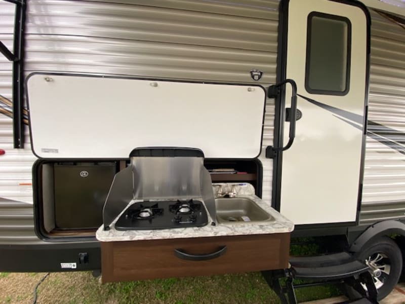 2 burner outdoor gas stove-top and sink.  Small drink fridge