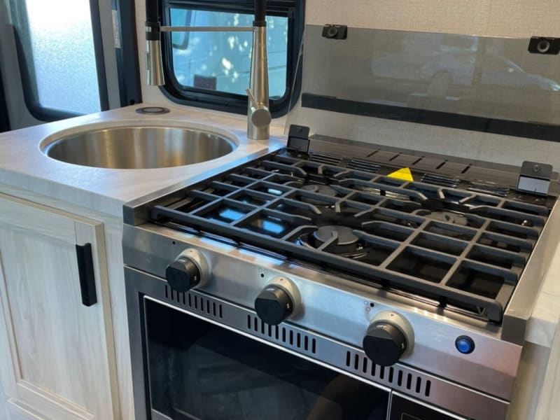 3 burners stove/ microwave but can also use as traditional oven/ flip up countertop on the left of the sink (not show in the pictures)