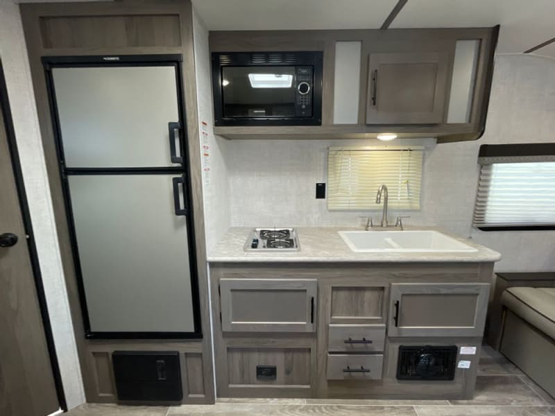 Great kitchen set up with full refrigerator and freezer, double sink, microwave and stove!