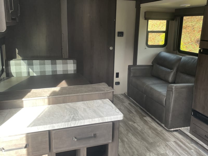 Smart TV over dining table. Pantry is located between dining area and bunkroom. Shoe storage on the left as soon as you step into the RV.