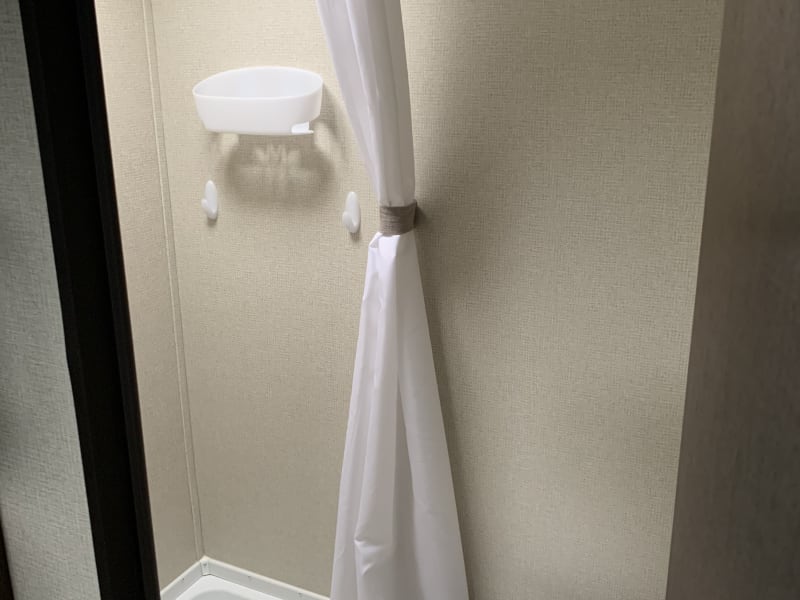 Shower in the bathroom with shower curtain.