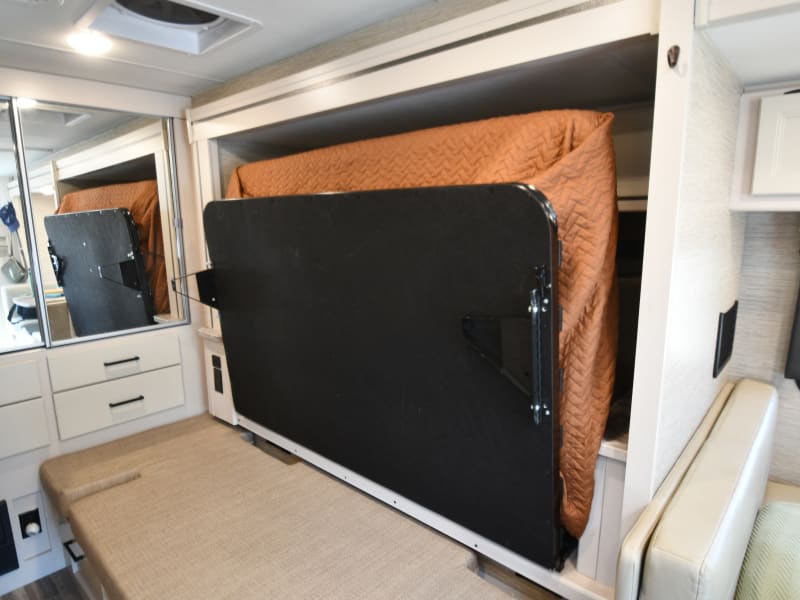 Main bed folded up (gives sitting area in front of TV while slide out)