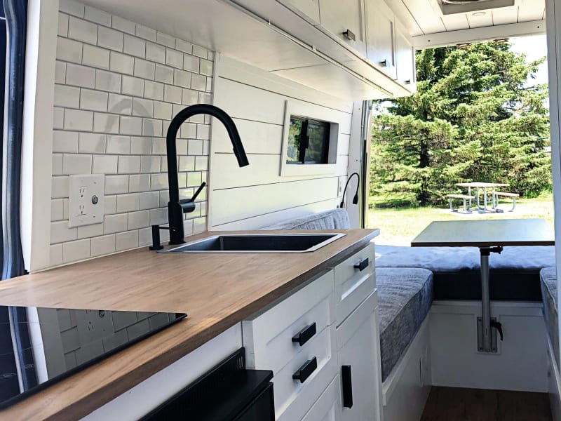 Kitchen Area:  Refrigerator, Induction Stove, Deep Sink, Under Sink Storage.  Plenty of space to cook and eat!