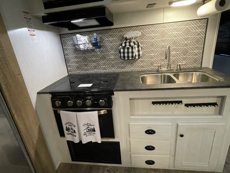 oven, stove, sink and cabinets