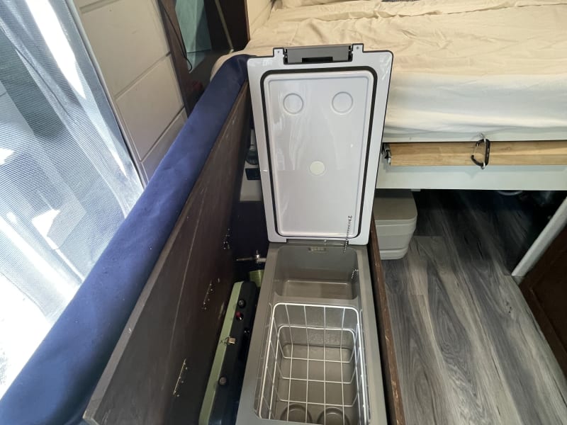 Your refrigerator is solar powered and fits right under the seat! Portable cookstove is right next to it.