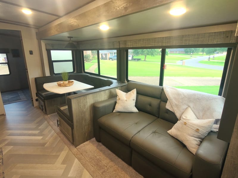 The main slideout features a dinette and pull out sleeper couch. 