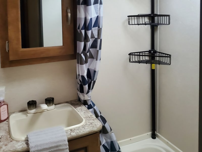 Mirror storage is empty for your things. Shower has a new shower head for better pressure.