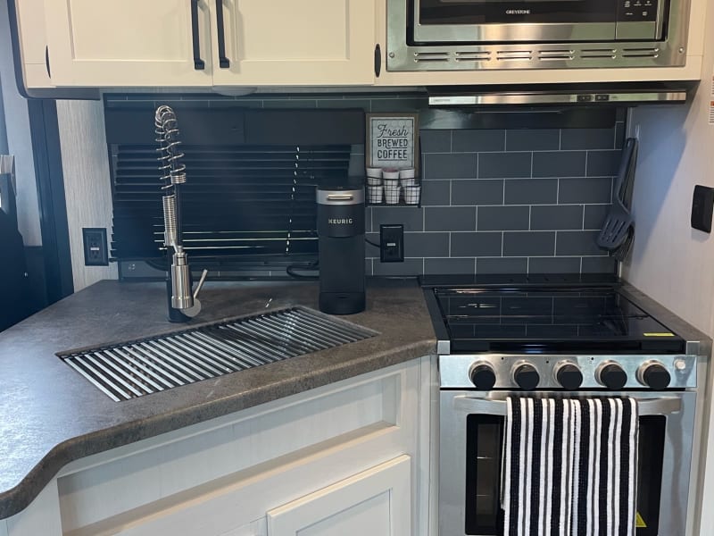 Plenty of storage! Gas cooking, microwave, all kitchen utensils/pots/pans included, deep double sink, brand new Keurig, stainless steel French Press.