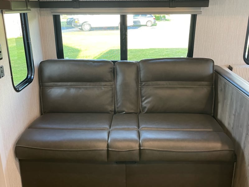 Comfortable Jackknife sofa with over-head storage. Above you'll find a toaster and electric kettle. Folds out to be a very comfortable space to sleep!