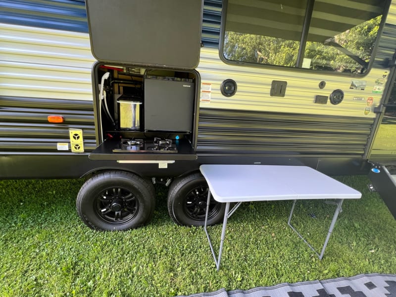 Outdoor Cooking area with mini fridge, hose and ice maker