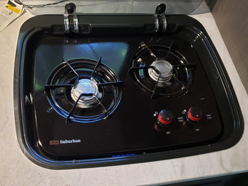 Two burner gas cook top.  Needs to be manually lit.  Lighter is included