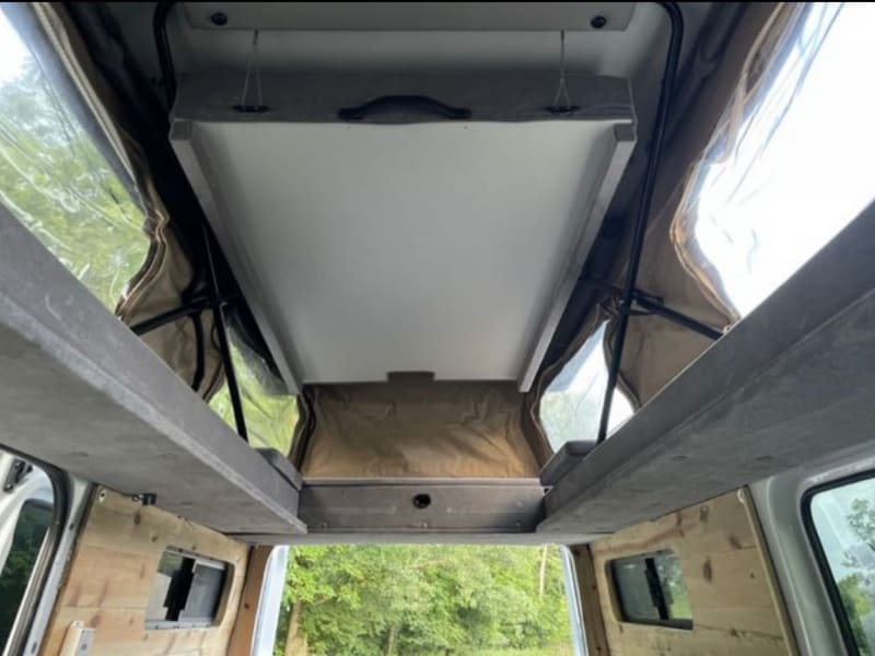 View with upper bed lifted on the pop top.