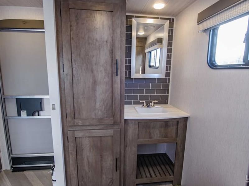 Spacious cabinets and under-sink storage in bathroom