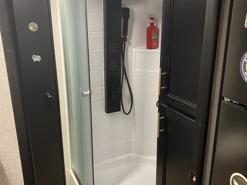 Full shower with massage pressure settings and handheld hose