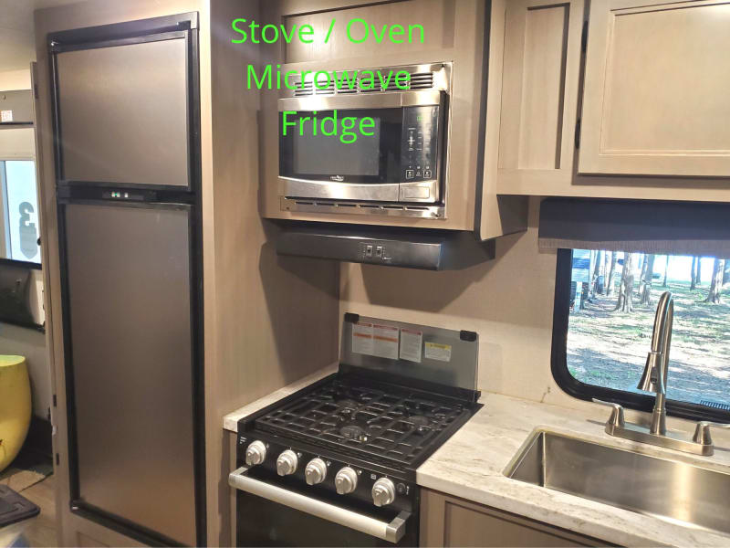 Fridge and Freezer, Gas 4 burner cook top, Oven, Microwave, and of course sink. Coffee Pot, food storage containers and lots of other kitchen items