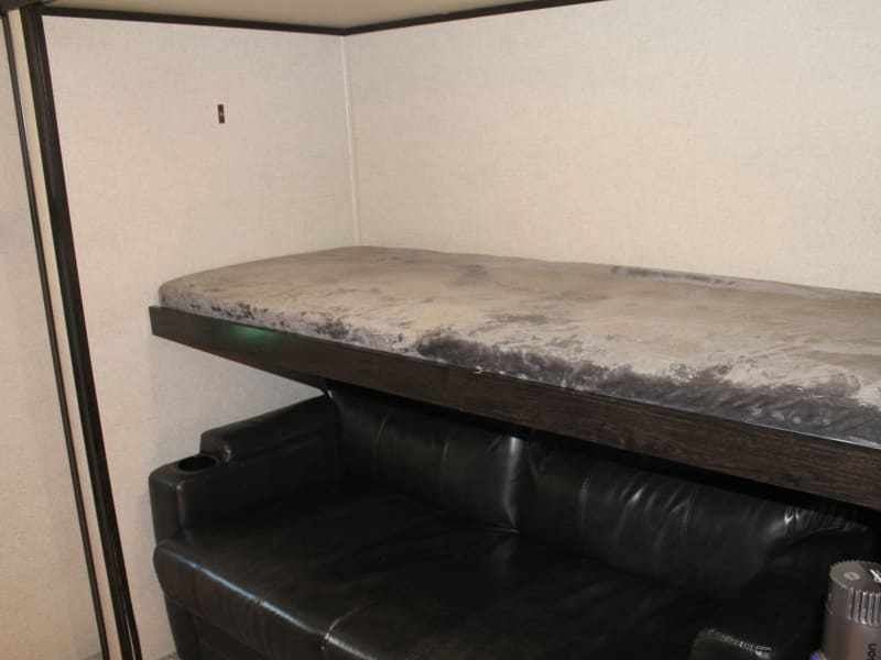 Fold down single bunk above love seat