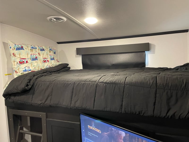 Top bunk over entertainment system 