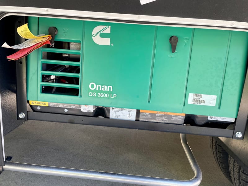 Onan QG 3600 Liquid Propane generator. Powers the AC (alternating current) elements including AC (Air conditioning), TV, Microwave and power outlets.